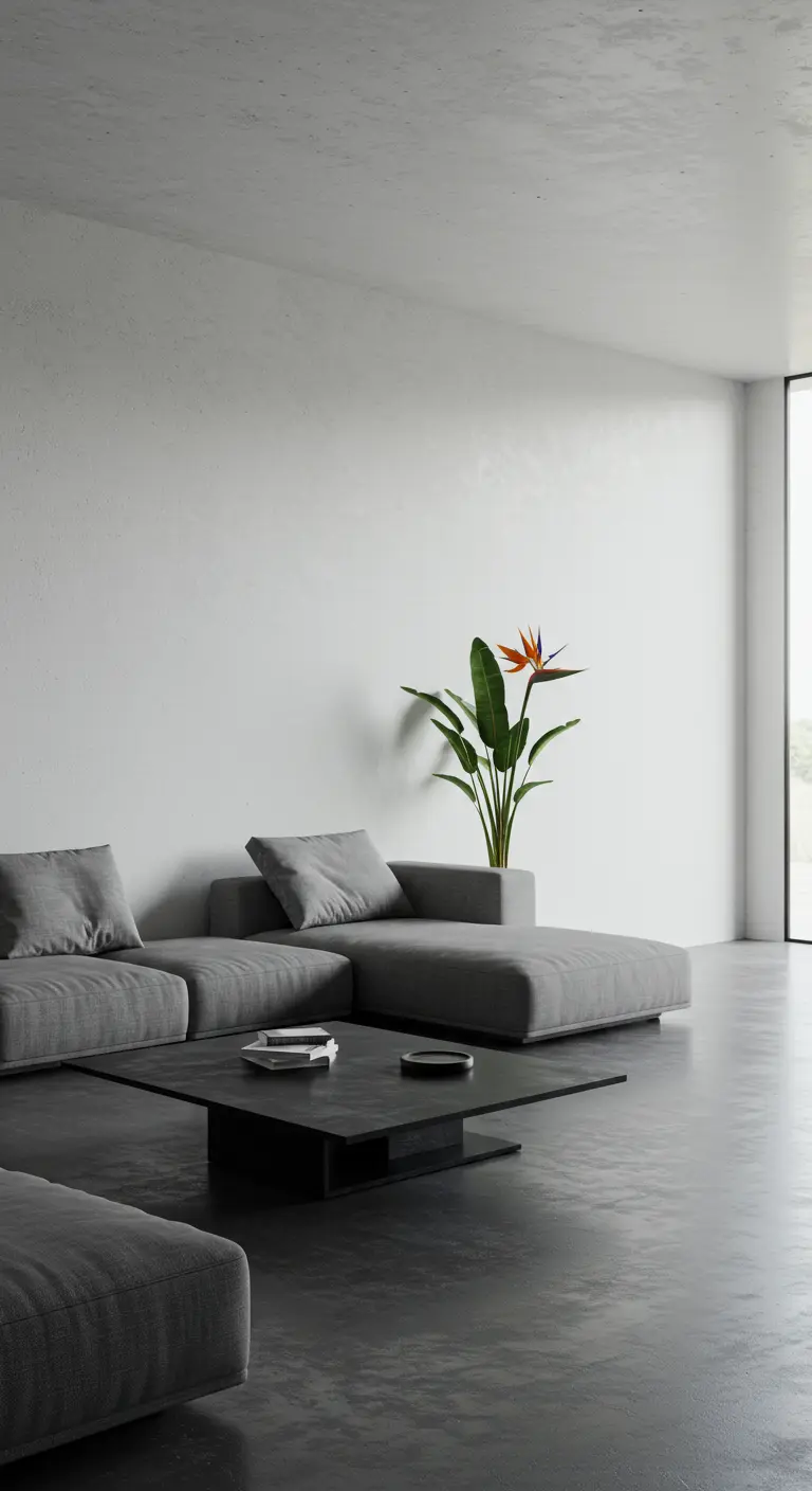 Salon minimaliste avec canapé d'angle gris et une plante oiseau de paradis dans un pot intégré.